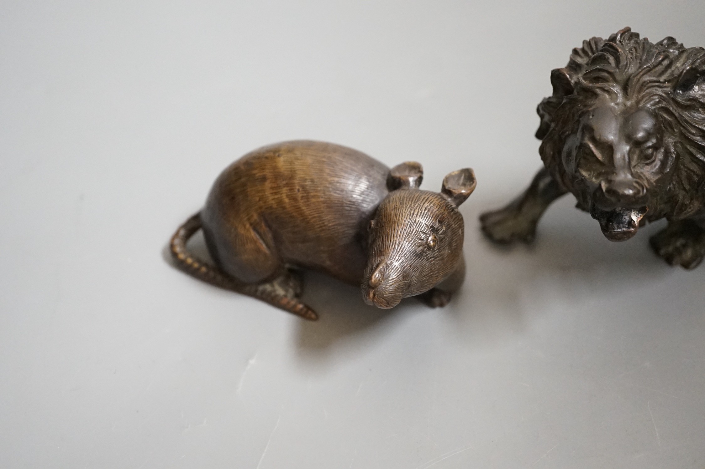 A bronze figure of a rat and another of a lion, 16cm wide